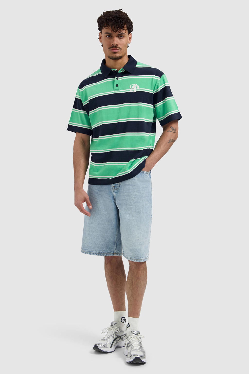 Groene heren Pure Path relaxed gestreepte polo van katoen met korte mouwen en knoopsluiting